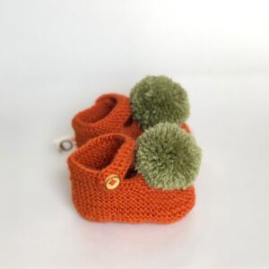 rust pompom baby booties