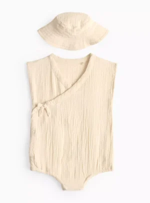 cream wrap romper and sun hat
